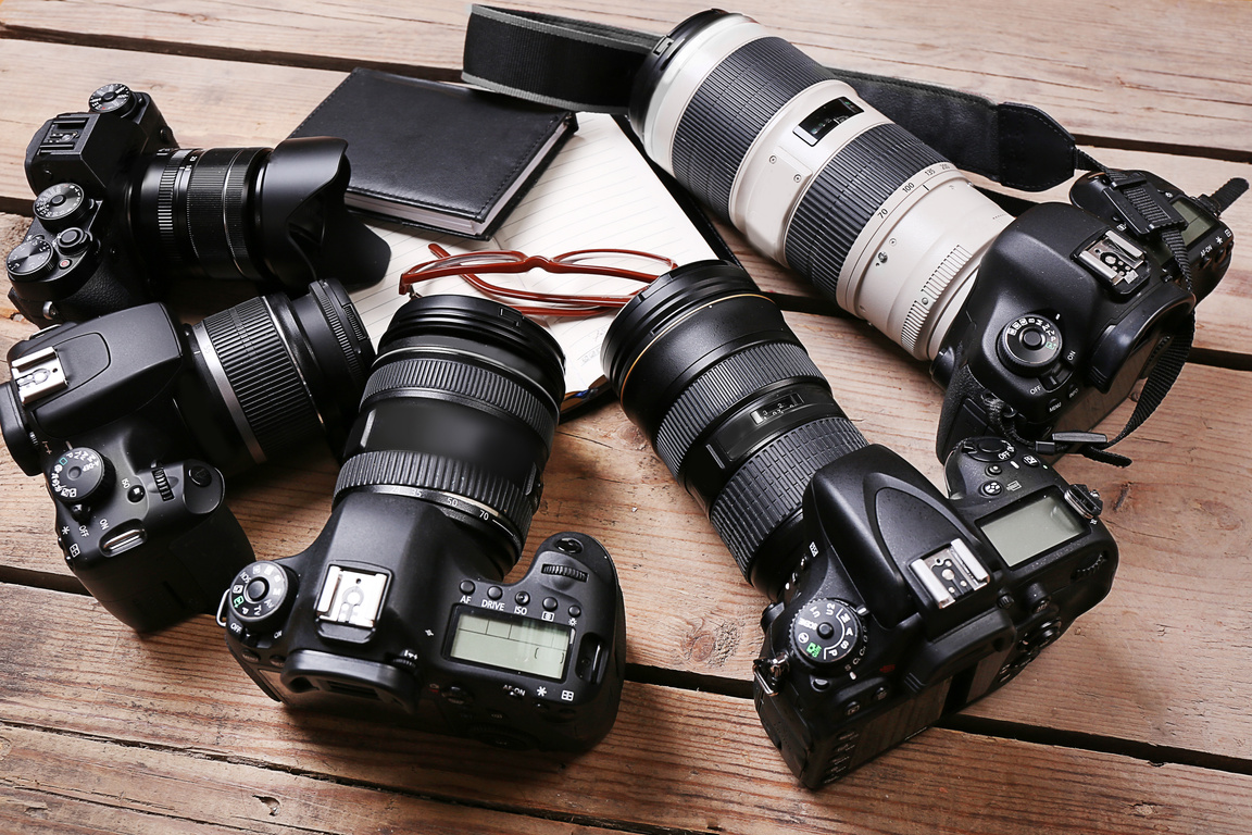 Modern Cameras on Wooden Table, Closeup