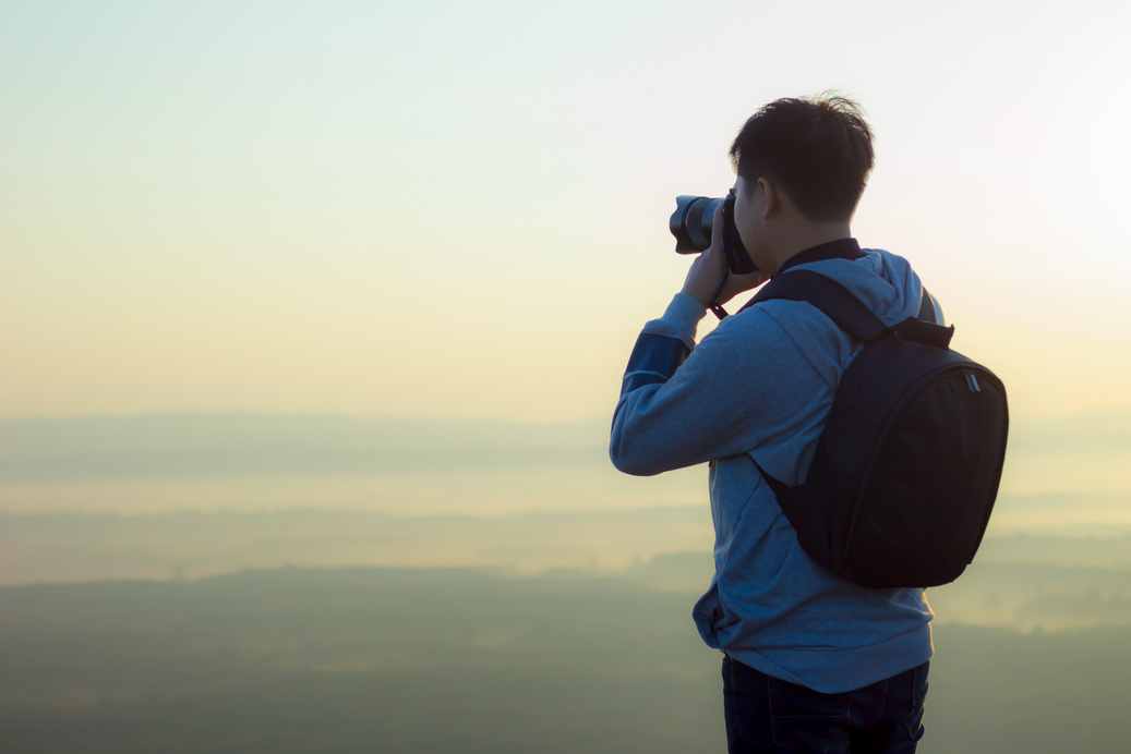 Man Taking Photographs of the Scenery