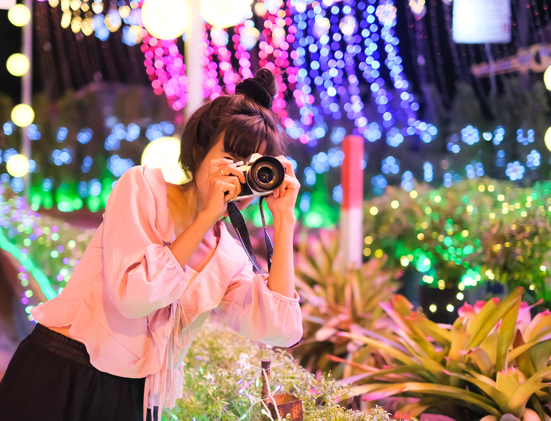 Woman Holding Camera Taking a Photo inthe Festival